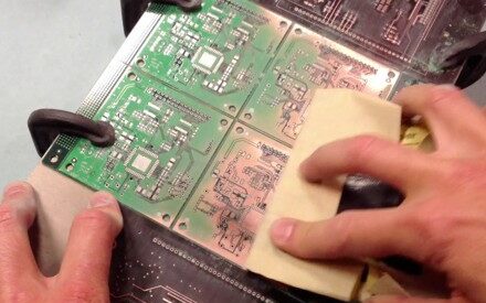 Hand sanding of a PCB to remove solder mask